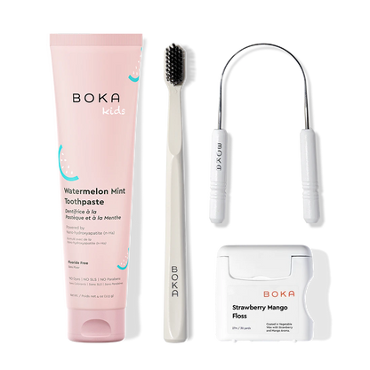 Boka dental care products including toothpaste, toothbrush, Tongue Scraper and floss on a white background