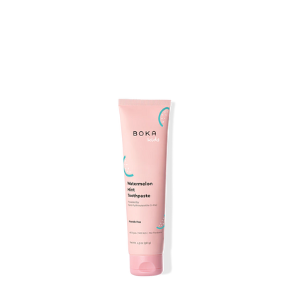Pink tube of Boka toothpaste on a white background