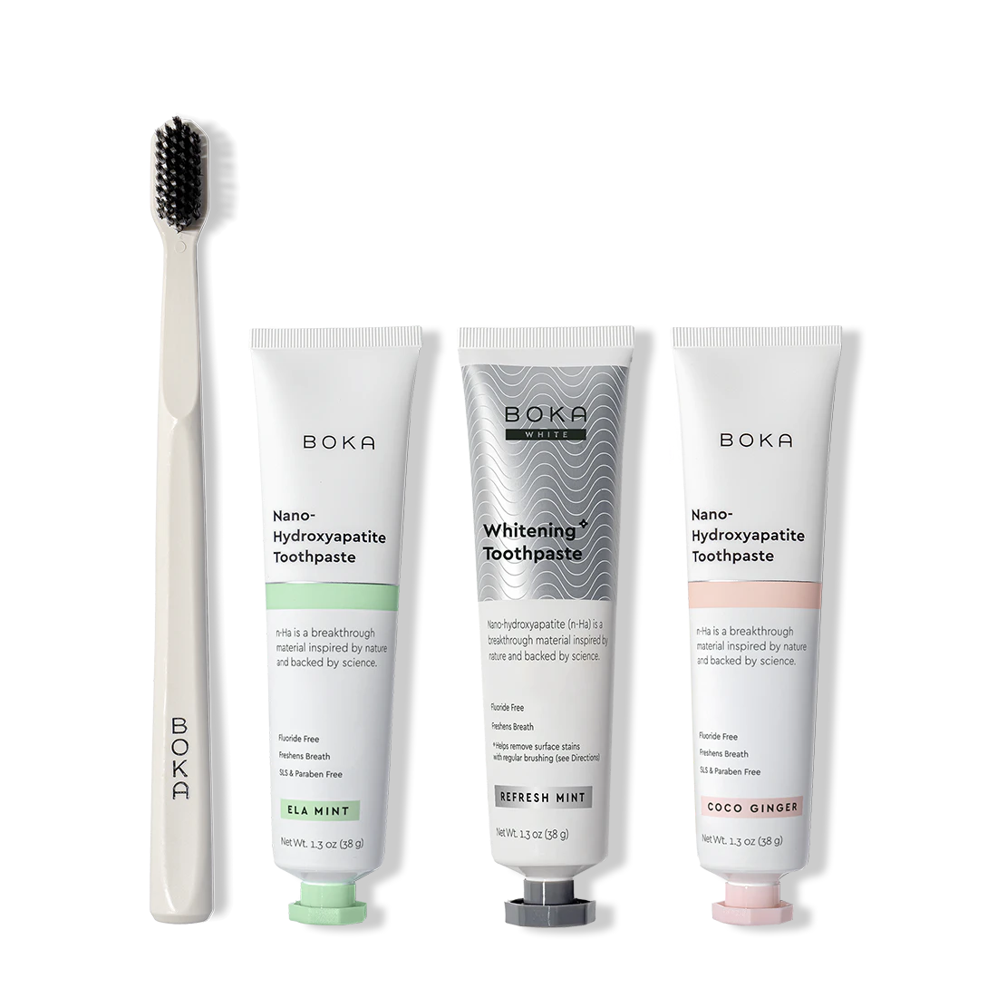 Boka toothpaste tubes and a toothbrush on a white background