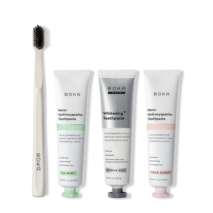 Boka toothpaste tubes and a toothbrush on a white background