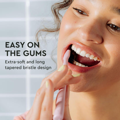 Woman brushes with Classic Toothbrush 2-Pack; gentle clean fights odor and is easy on gums.