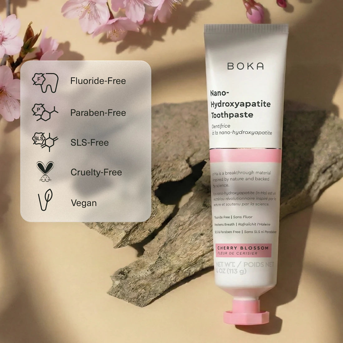 Boka Nano-Hydroxyapatite Toothpaste with cherry blossom flavor on a beige background with floral elements.