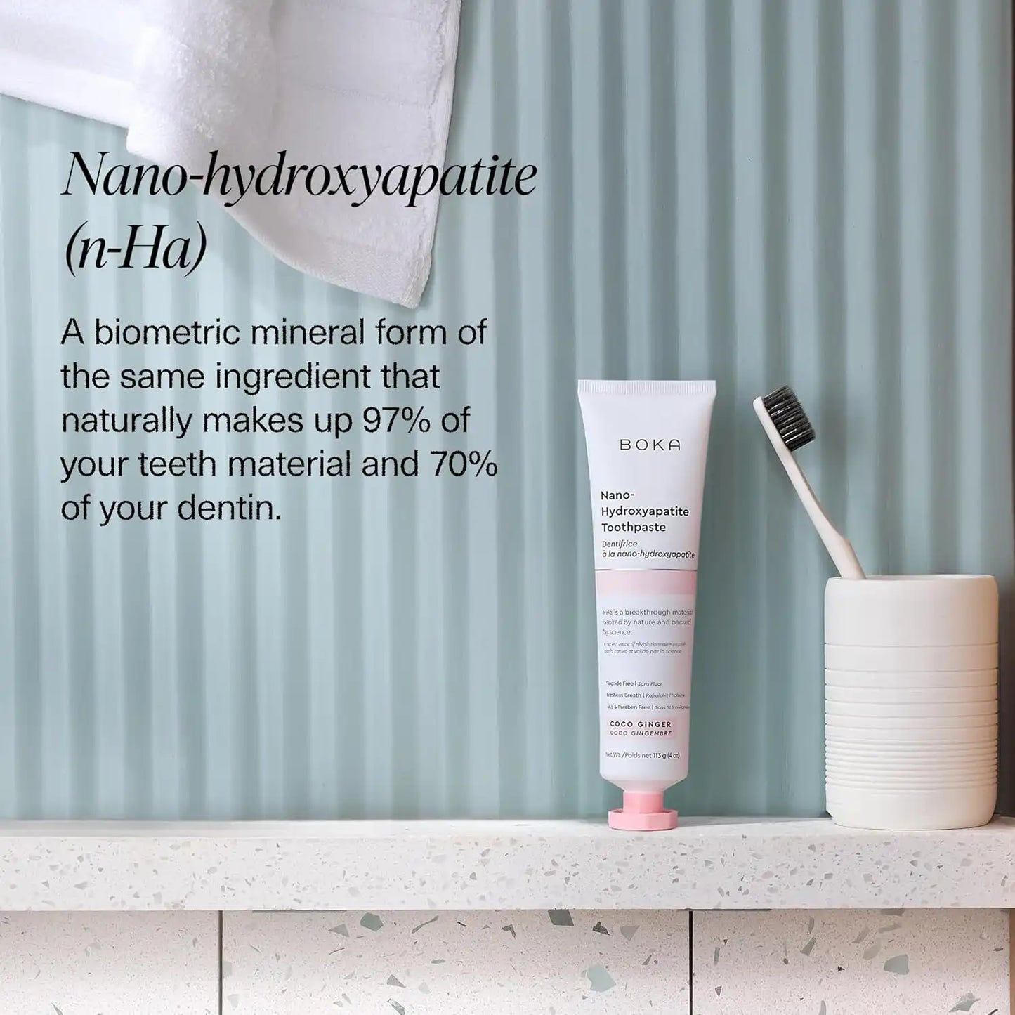 Boka Nano-hydroxyapatite toothpaste tube with a toothbrush on a bathroom shelf.