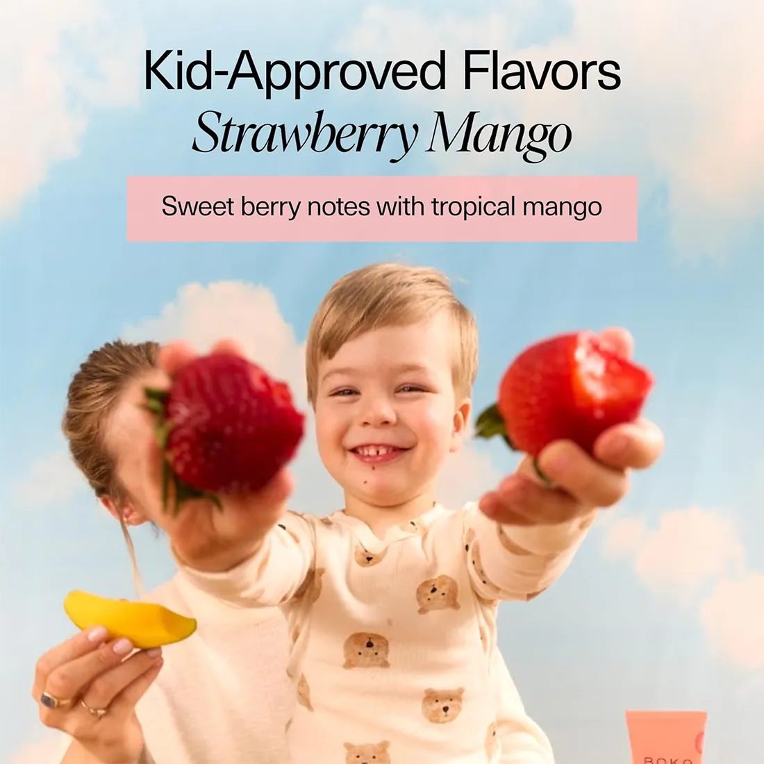 Child holding strawberries with text about 'Kid-Approved Flavors Strawberry Mango' against a blue sky.